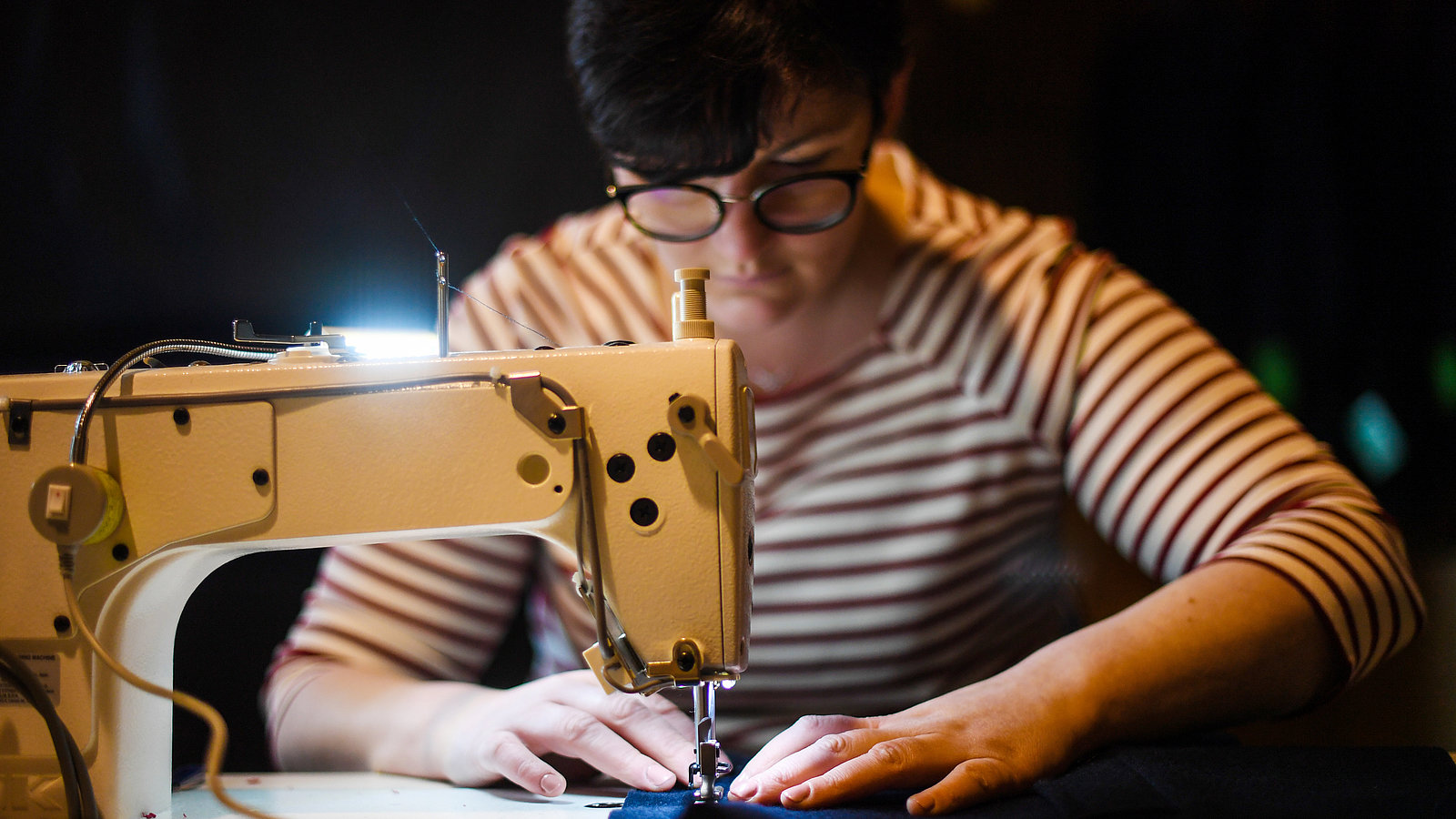 Seamstress who recycles wool coats in her workshop